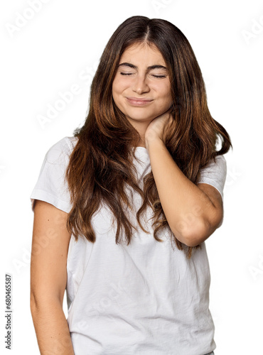 Young Caucasian woman in studio setting having a neck pain due to stress, massaging and touching it with hand.
