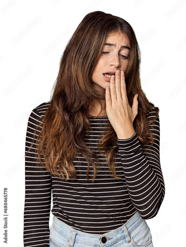 Young Caucasian woman in studio setting yawning showing a tired gesture covering mouth with hand. Young Caucasian woman in studio setting yawning showing a tired gesture covering mouth with hand.