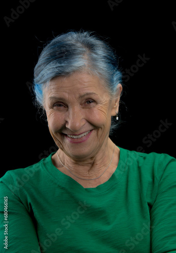 senior woman smiling portrai looking into lens 