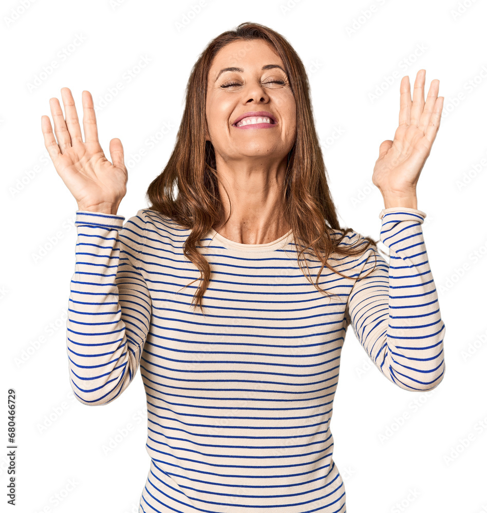 Middle-aged woman portrait in studio setting joyful laughing a lot. Happiness concept. Middle-aged woman portrait in studio setting joyful laughing a lot. Happiness concept.