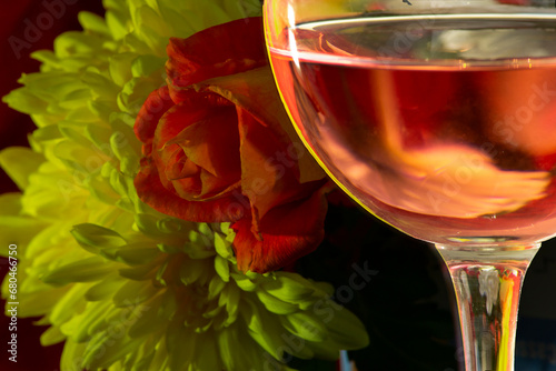 glass with wine and flowers