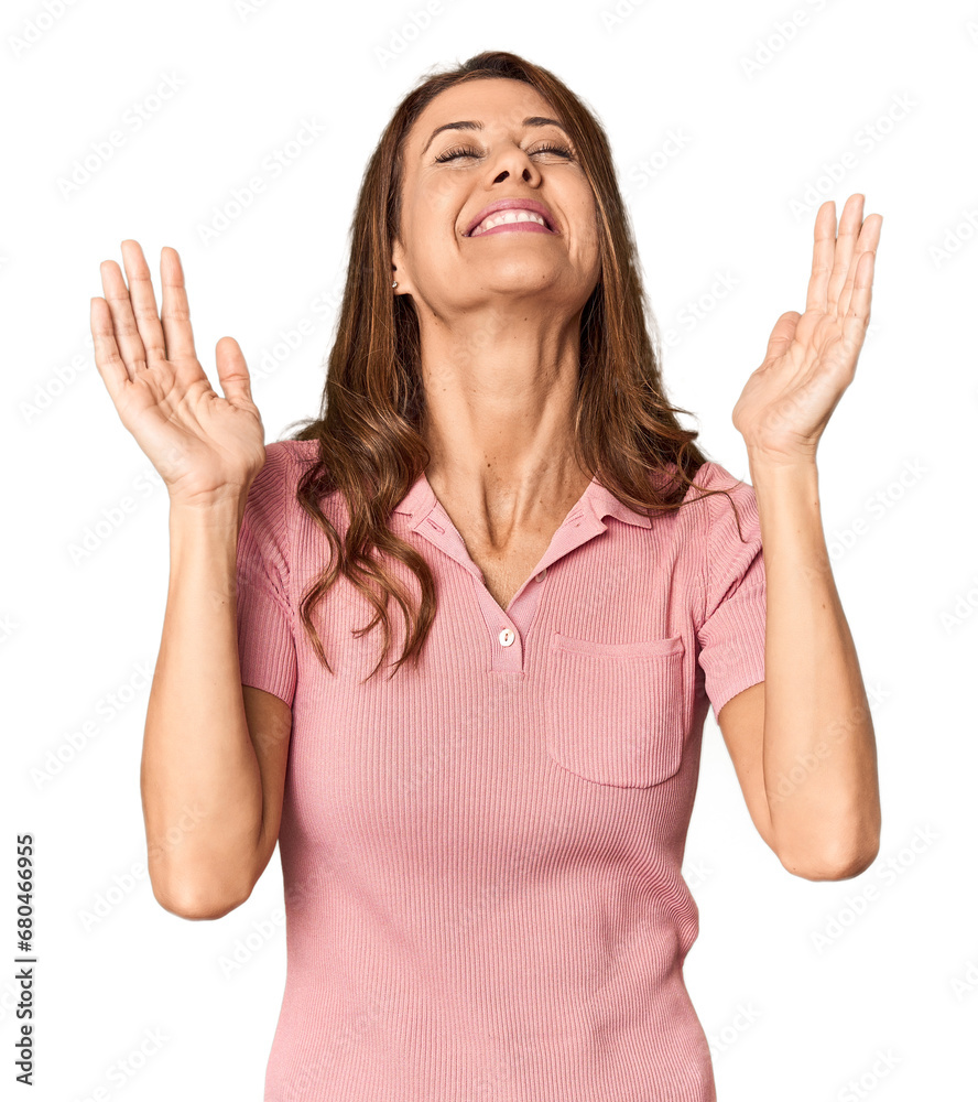 Middle-aged woman portrait in studio setting joyful laughing a lot. Happiness concept. Middle-aged woman portrait in studio setting joyful laughing a lot. Happiness concept.