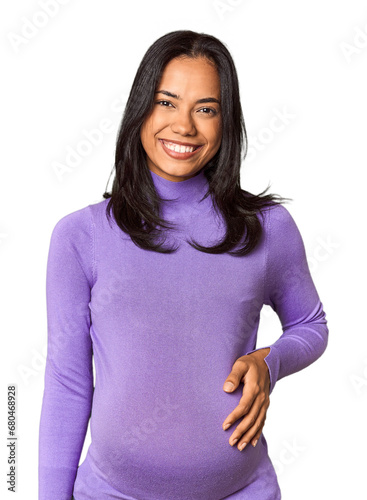 Young Filipina woman expecting a baby in studio happy, smiling and cheerful.