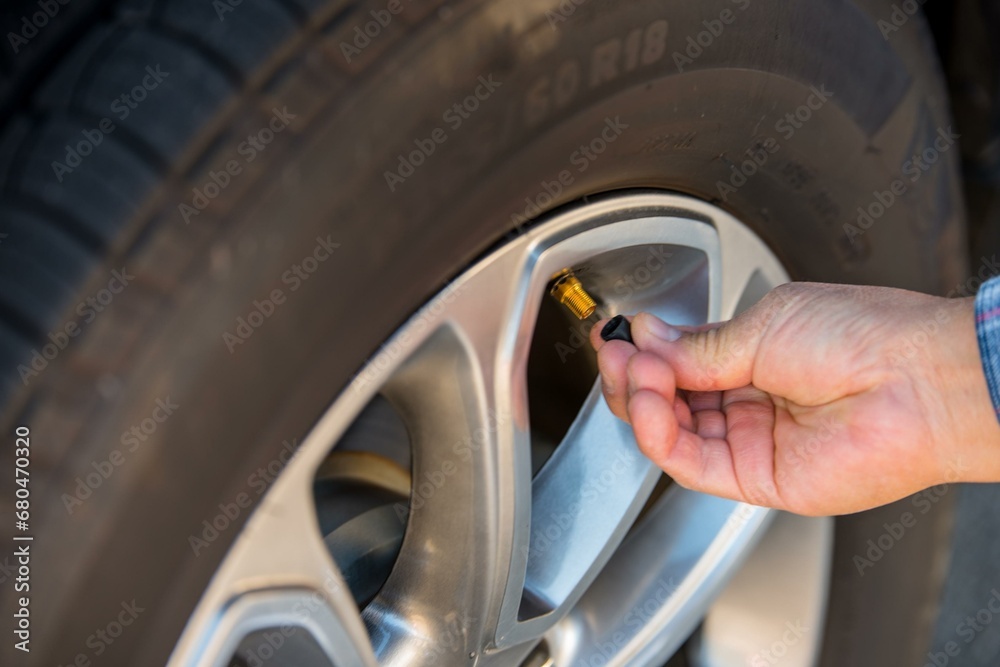 4K Image: Close-Up of a Man Checking Tire Valve Stem 4K Image: Close-Up of a Man Checking Tire Valve Stem