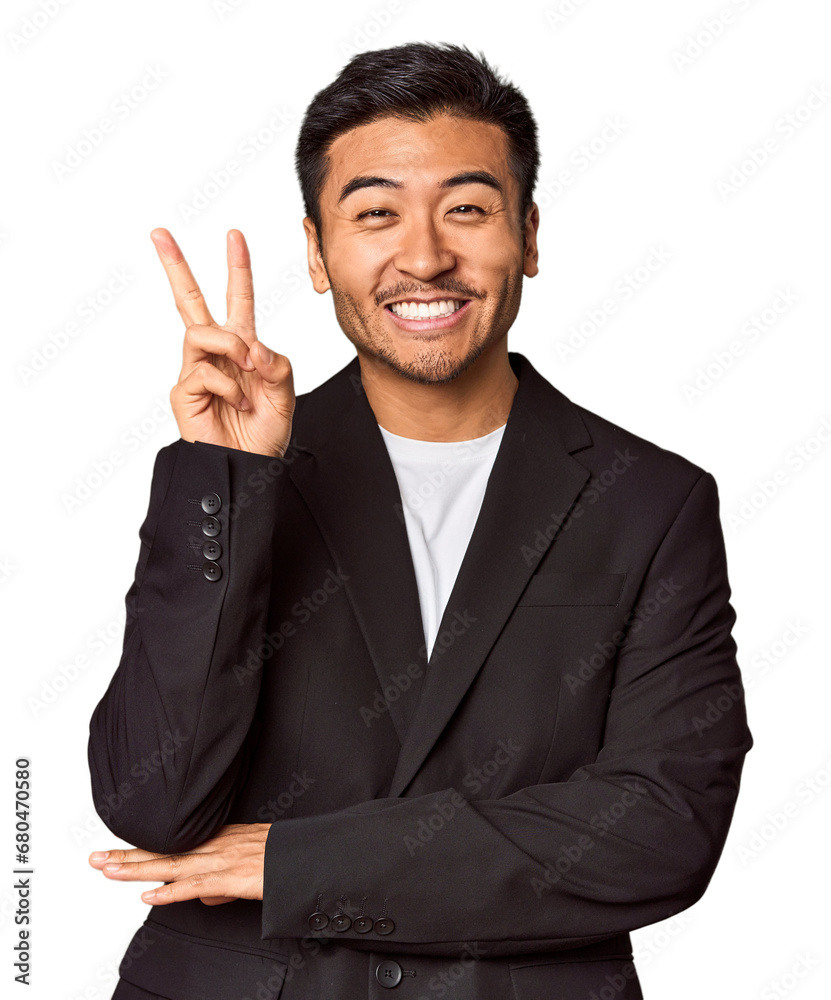 Young Chinese man in business suit in studio showing number two with fingers. Young Chinese man in business suit in studio showing number two with fingers.