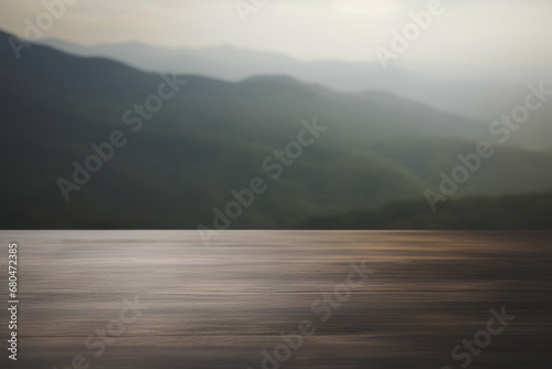 a rustic wooden table top with a blurred mountain valley background © Suplim