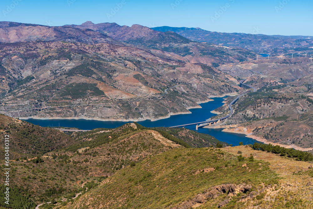 View from Sierra Lujar of the Rules reservoir and the highway that goes from Granada to the tropical coast, Andalucia.