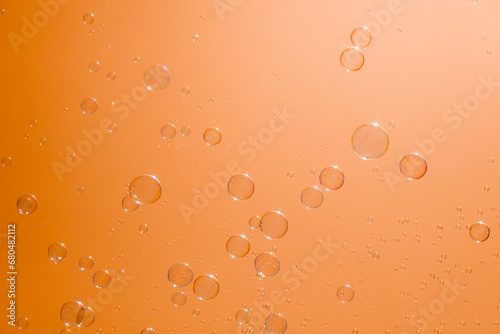 Soap bubbles in the orange sky. Beautifully iridescent balls of soap foam in the air
