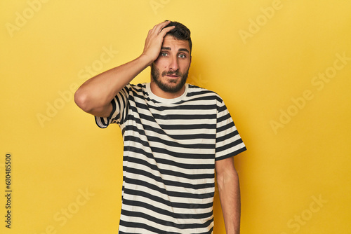 Young Hispanic man on yellow background being shocked, she has remembered important meeting.