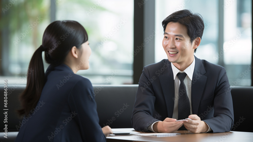 Businessman and businesswoman discussing work in the office. Asian people Businessman and businesswoman discussing work in the office. Asian people