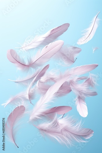white feathers fly in the air on blue pastel background © dashtik