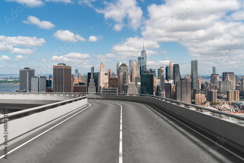 Empty urban asphalt road exterior with city buildings background. New modern highway concrete construction. Concept of way to success. Transportation logistic industry fast delivery. New York. USA.