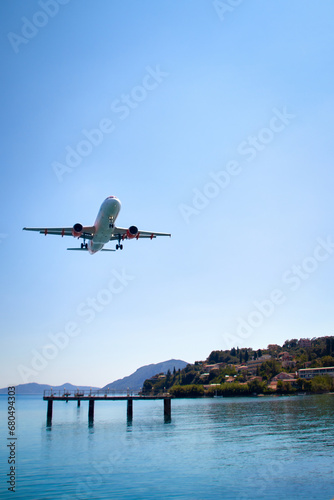 an airplane approaching Corfu town, close to the sea, Landing approach to Kerkyra Airport, Corfu Town Greece