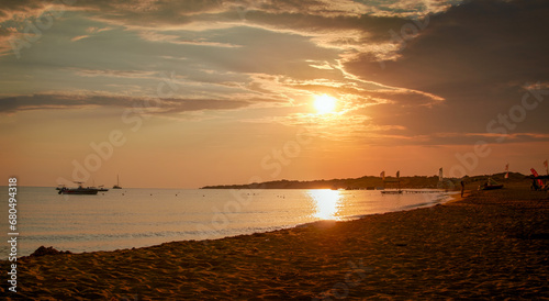 Panorama of a beautiful bay with boats on the west coast on a sandy Corfu beach in the evening sunlight  Greece