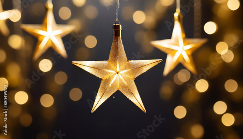 Gold star light hanging on dark background