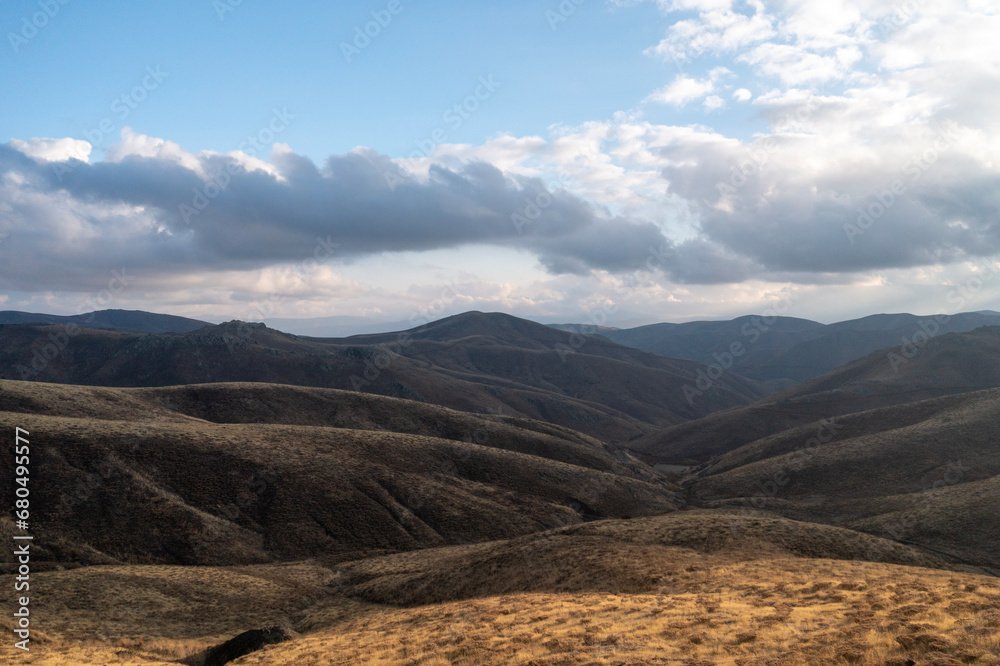 Mountain hills glowing in sunlight over highway in mountains with perfect blue sky.wonderful sunny scene. Highway, the most beautiful road in Turkey