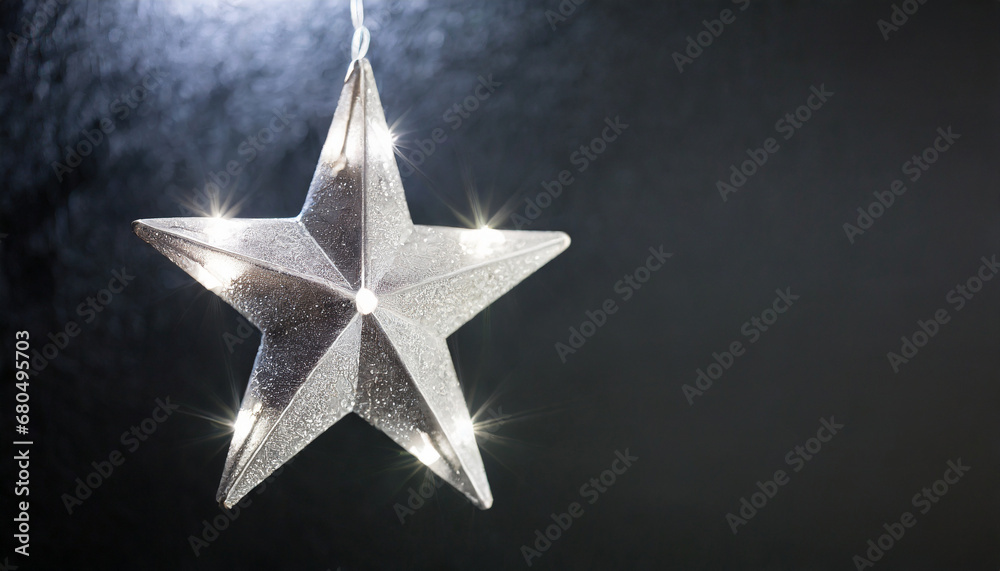 Silver star light hanging on dark background Silver star light hanging on dark background