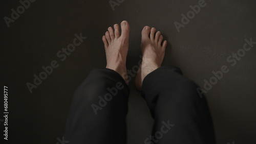 Man sitting on a couch and making feet streych excercise