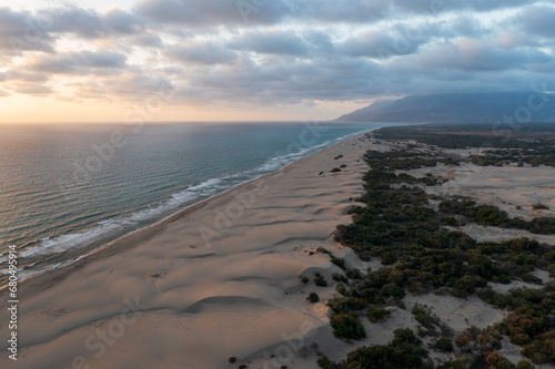 Beach and waves from top view. Turquoise water background from top view. Summer seascape with dunes from air. Top view from drone. Travel concept and idea