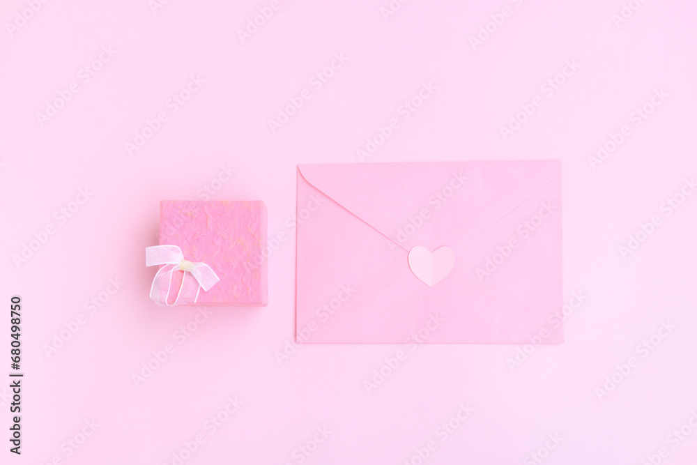 Pink envelope, Pink gift box and pink heart shape papercut on pink background, Love and Valentine concept Pink envelope, Pink gift box and pink heart shape papercut on pink background, Love and Valentine concept