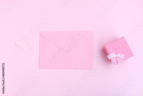 Pink envelope, Pink gift box and pink heart shape papercut on pink background, Love and Valentine concept