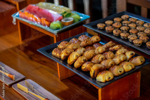 Assortment baked pastry in the buffet. Various different types of sweet cakes, cookies, candies, fruits and other desserts on display. Catering for birthday, wedding, Sunday brunch or other event