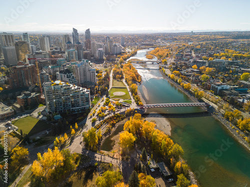 Prince's Island Park Peace Bridge autumn foliage scenery. Aerial view of Downtown City of Calgary. Alberta, Canada.