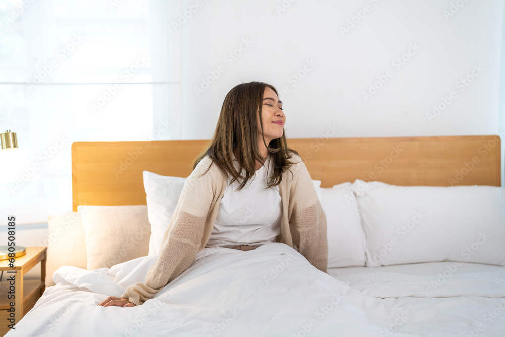 Portrait of smiling beauty pretty asian woman comfortable fresh healthy smile happy and relax in pajamas white clothes, happy calm, resting, breathing fresh air.Girl felling wellbeing enjoy at home