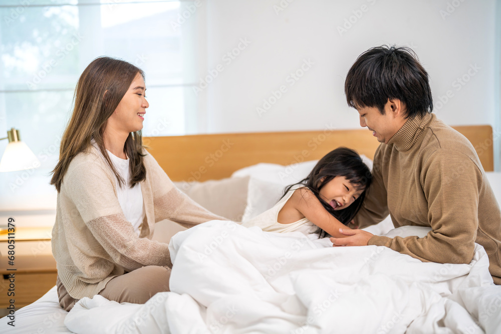 Portrait of enjoy happy love asian family father and mother holding hug cute little asian girl child smiling play and having fun moments good time, care, kid, support, insurance, child, at home Portrait of enjoy happy love asian family father and mother holding hug cute little asian girl child smiling play and having fun moments good time, care, kid, support, insurance, child, at home