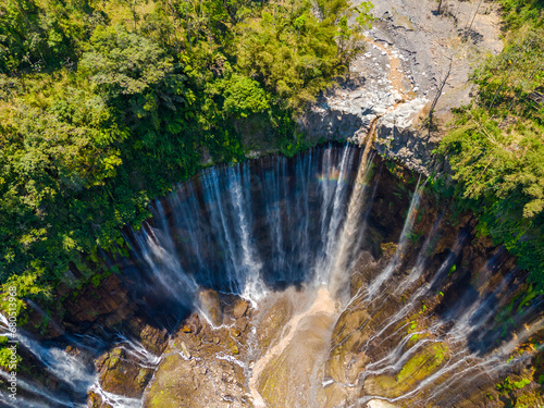 Aerial view from above, stunning view of Tumpak Sewu waterfall with many streams also known as Coban Sewu in East Java, Indonesia photo