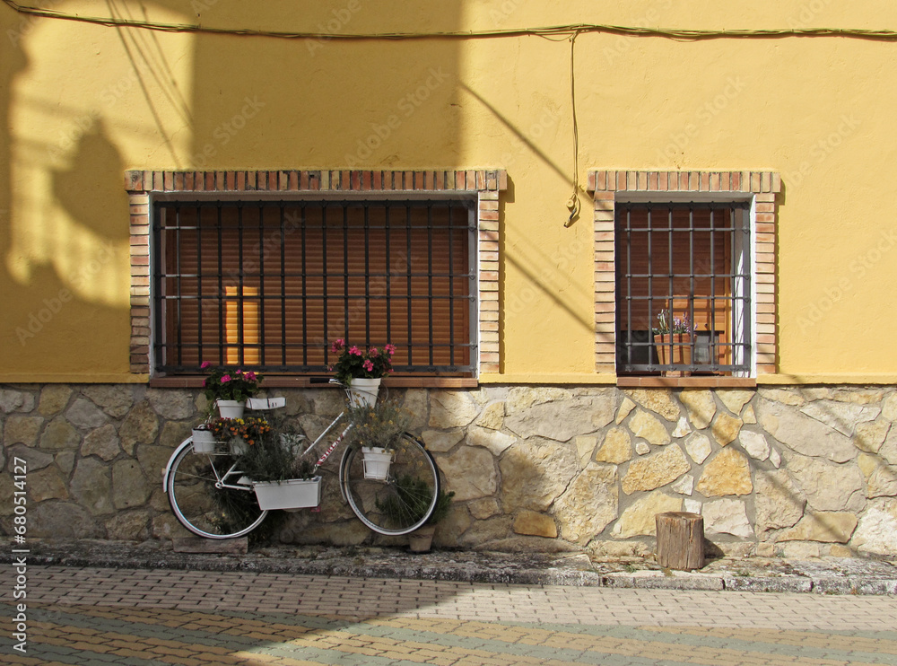 Decorative bicycle with flower pots in front of a stone house in Uña, Cuenca.  