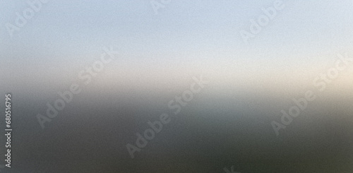 Sunrise through a window covered with ice. Matte blurred gray grainy background for website banner. Desktop design. Large, wide template, pattern. Color gradient, blur. Unfocused, colorful mix, bright