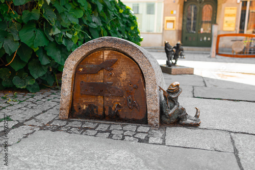 Fototapeta Naklejka Na Ścianę i Meble -  Wroclaw, Poland - June 2023: Wroclaw Dwarf. The small figurines in the streets of Wroclaw old town. Hunting for dwarfs, tourist attraction. High quality photo