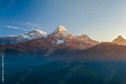 Machapuchhare or Machapuchare mountain peak in the Annapurna range, seen from Poon Hill trek trail in Pokhara, Himalayas, Nepal photo