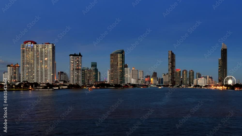 A view of buildings with a river in the foreground of Bangkok city in the evening when the sky is clear and cloudless. In 4K time-lapse video A view of buildings with a river in the foreground of Bangkok city in the evening when the sky is clear and cloudless. In 4K time-lapse video