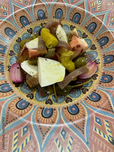 mozzarella cheese salad with mojama onion, tomato and pickles photo