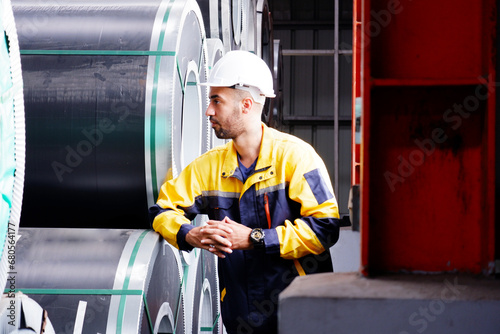 Mechanical engineering inspects machinery in a factory.