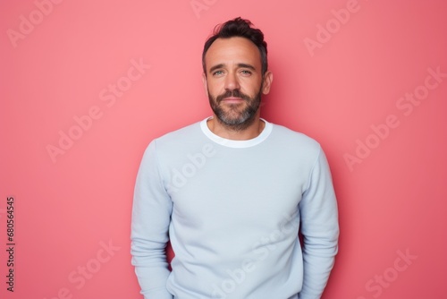 Portrait of a glad man in his 30s donning a trendy cropped top against a solid pastel color wall. AI Generation © CogniLens
