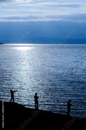 Silhouettes of 3 three fishermen
