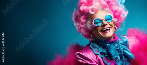 Elderly woman in carnival mask on solid color background, studio shot with copy space