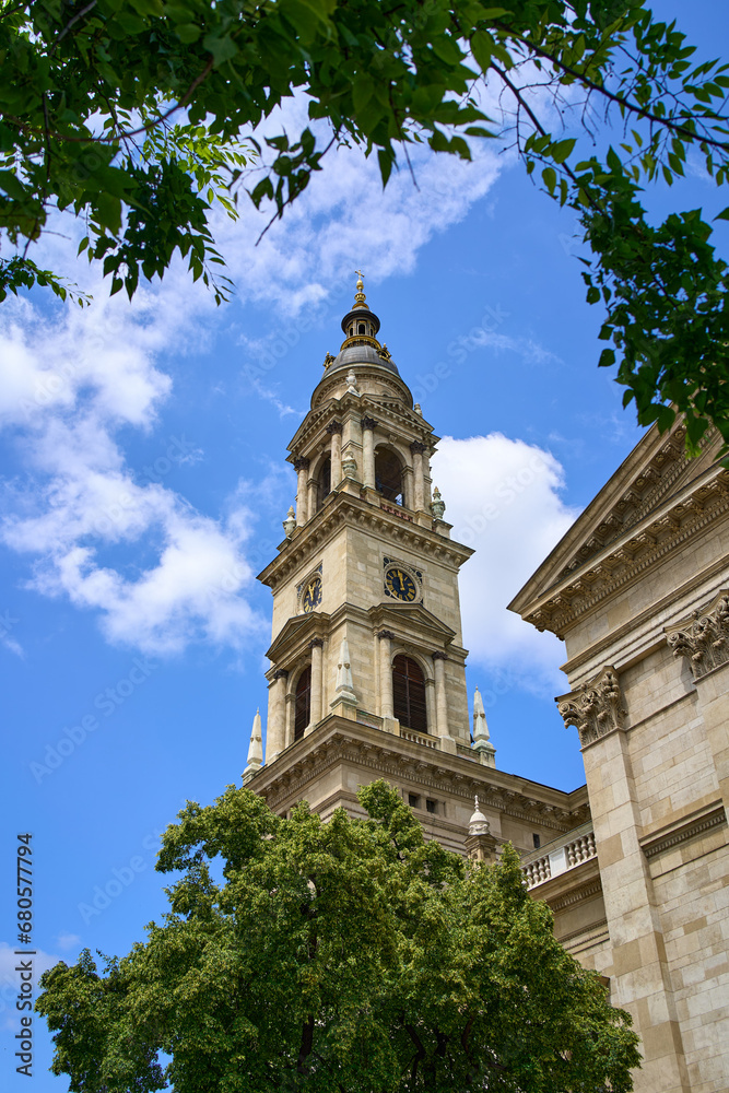 Close ups of the towers of St. Stephen's Basilica (Szent István Bazilika) among the trees in Budapest, Hungary.