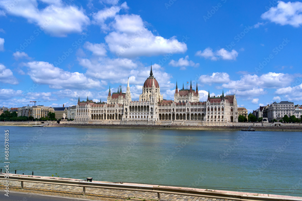 Hungarian Parliament Building on a summer day as seen from the opposing bank of the Danube river in central Budapest, Hungary. Hungarian Parliament Building on a summer day as seen from the opposing bank of the Danube river in central Budapest, Hungary.