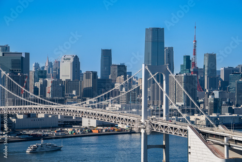 Photos View of Tokyo Skyline and Tokyo Bay with Rainbow Bridge on  a clear blue sky day