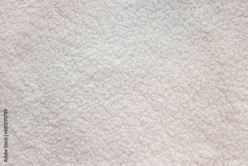White teddy bear faux fur fabric texture. Soft textile close up photo