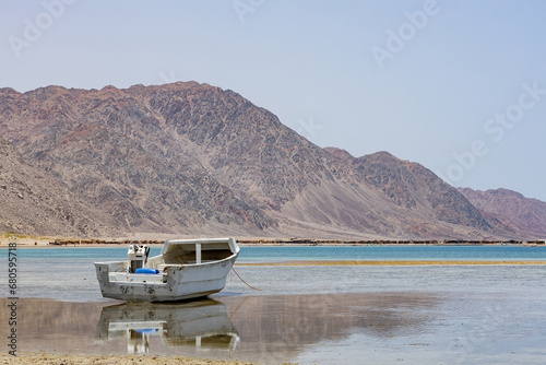 Fishing boat fat low tide Ras Abu Galum Egypt photo