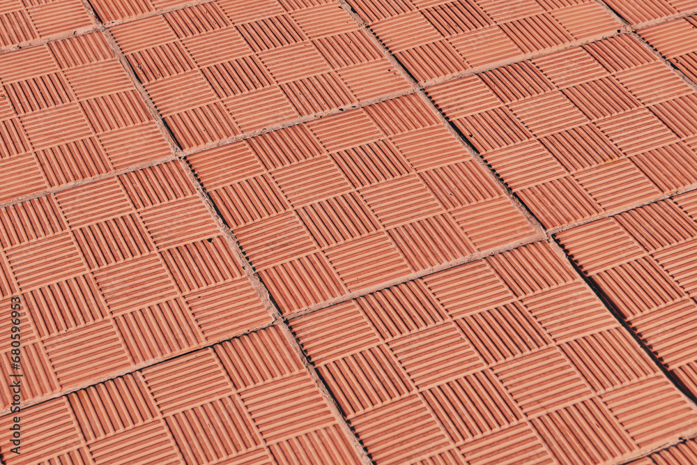 Brown clay tile texture close-up. Abstract orange background from grooved tiles Brown clay tile texture close-up. Abstract orange background from grooved tiles