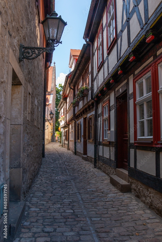 Timber-framed houses lining a narrow cobblestoned street in the Old Town of Erfurt, Germany