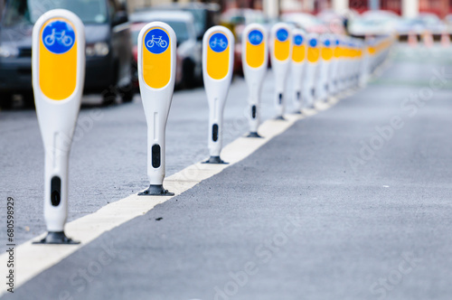 Row of bollards separating a cycle lane from motor vehicles. photo
