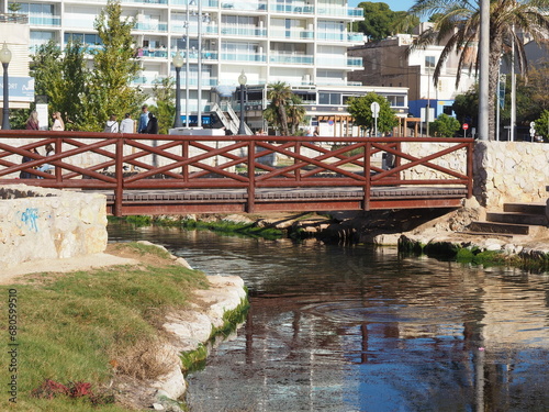 ría de comaruga desembocando en el mar mediterráneo, aguas cristalinas y con propiedades medicinales que son aprovechadas por los paseantes, tarragona, cataluña, españa, europa photo