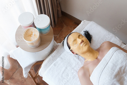 A girl on cosmetic procedures with a mask on her face